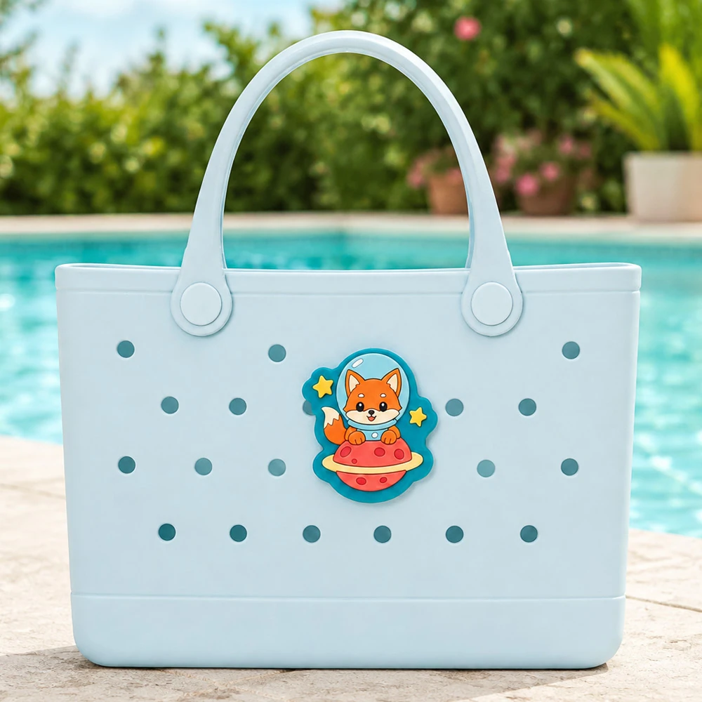 Custom soft PVC bag charm on a blue rubber tote by a swimming pool