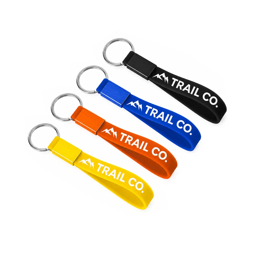 Custom silicone wrist loop keychains in black, blue, orange, and yellow
